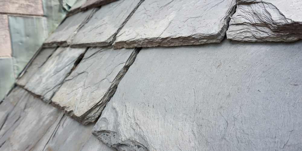 Close up of slate roof tiles on a historic building. Slate is a durable roofing material.