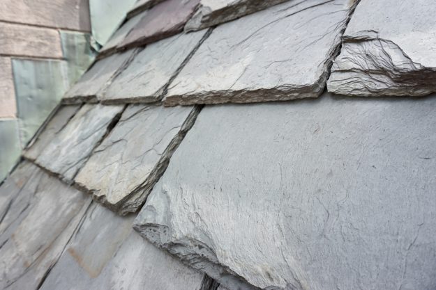 Close up of slate roof tiles on a historic building. Slate is a durable roofing material.