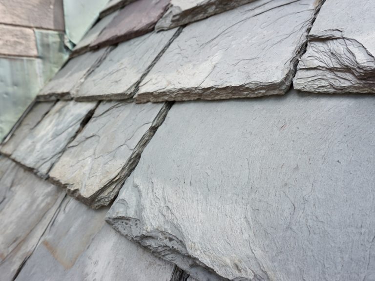 Close up of slate roof tiles on a historic building. Slate is a durable roofing material.